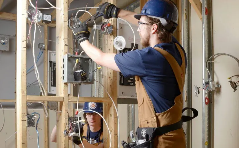 Licensed Primetime electrician wiring an electrical panel